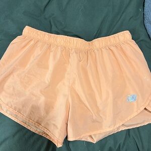 Orange New Balance women’s running shorts